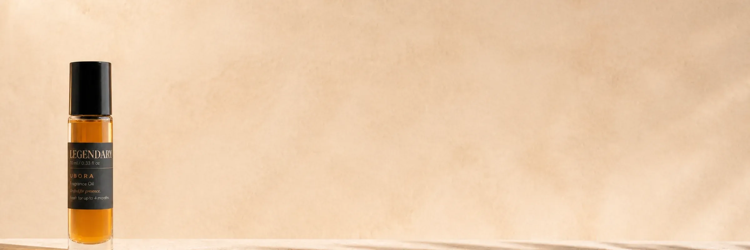 UBORA Legendary fragrance oil on a pale stone ledge